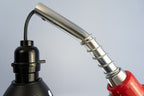 Car parts nozzle lamp transformed from real gas pump hardware into a functional and decorative light.