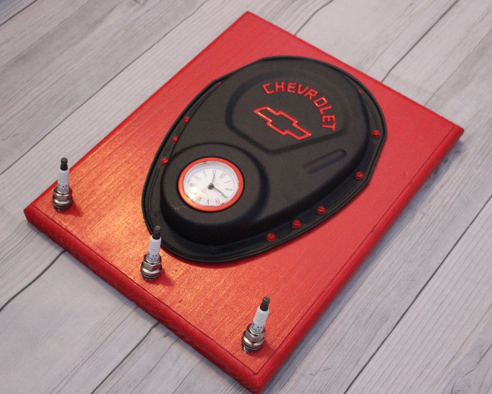 Chevrolet tire pressure monitor on a red stand with small bottles on a wooden floor.