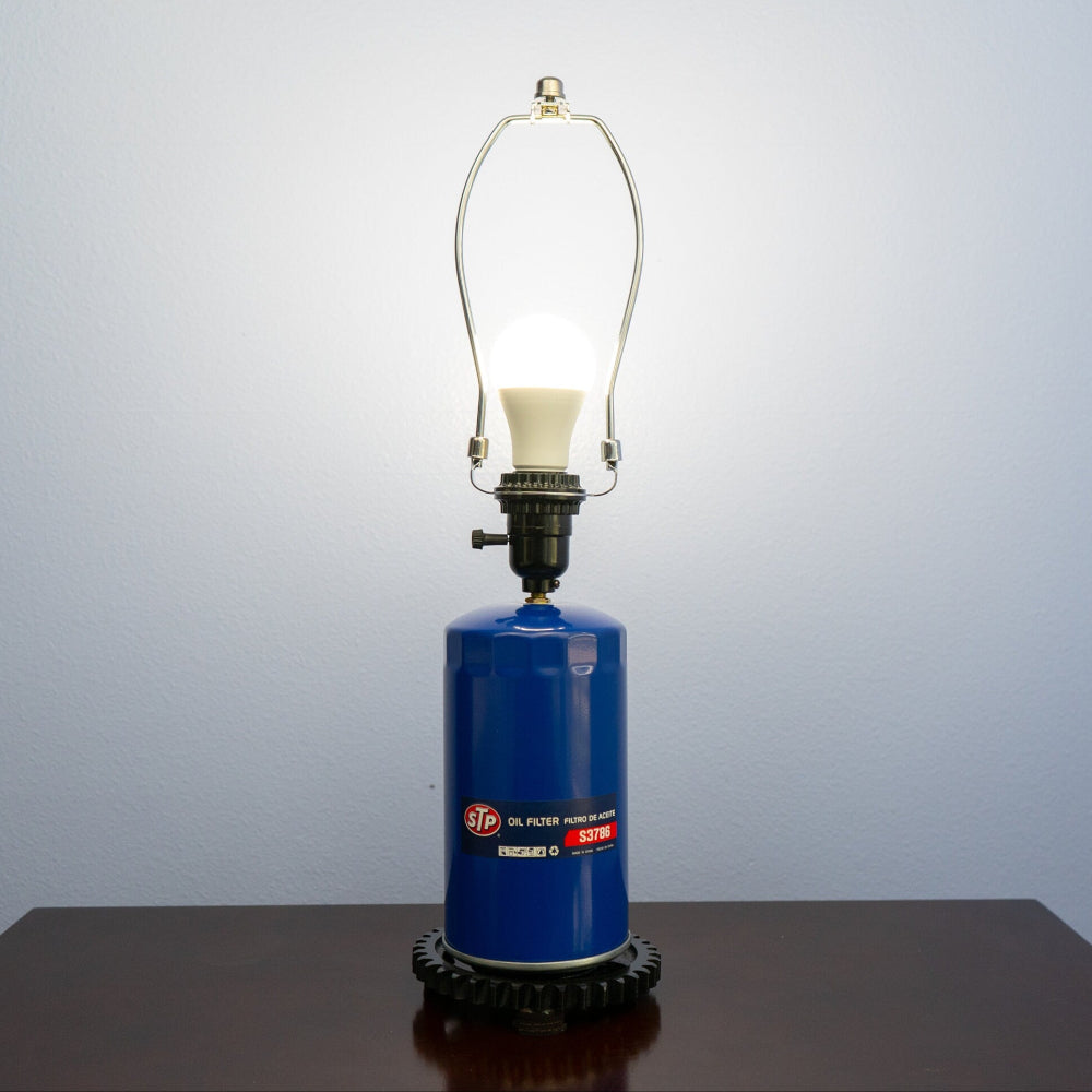 Classic car parts lamp made from an STP oil filter and industrial gear base.