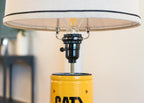 Desk lamp built from a real CAT oil filter, ideal for diesel mechanics and equipment operators.