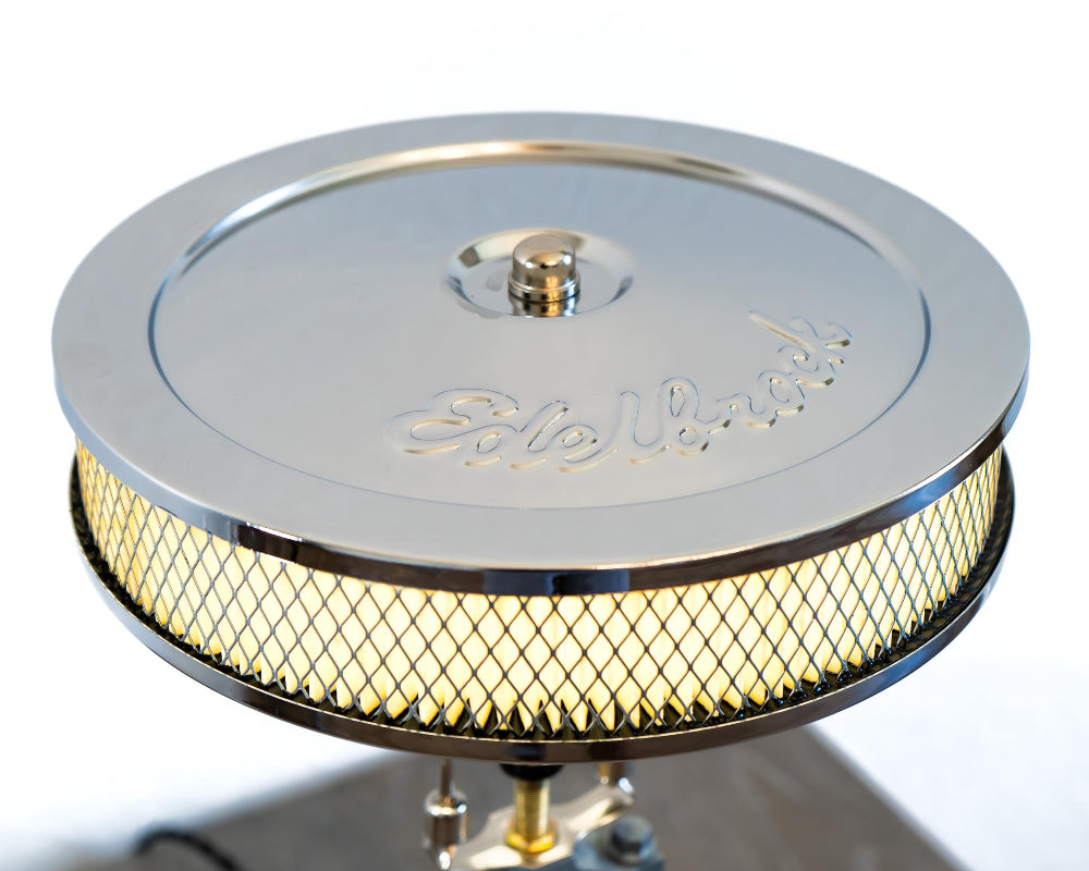 Industrial style Ford car part lamp created from a real piston and gear, offering durable construction and bold brand identity.