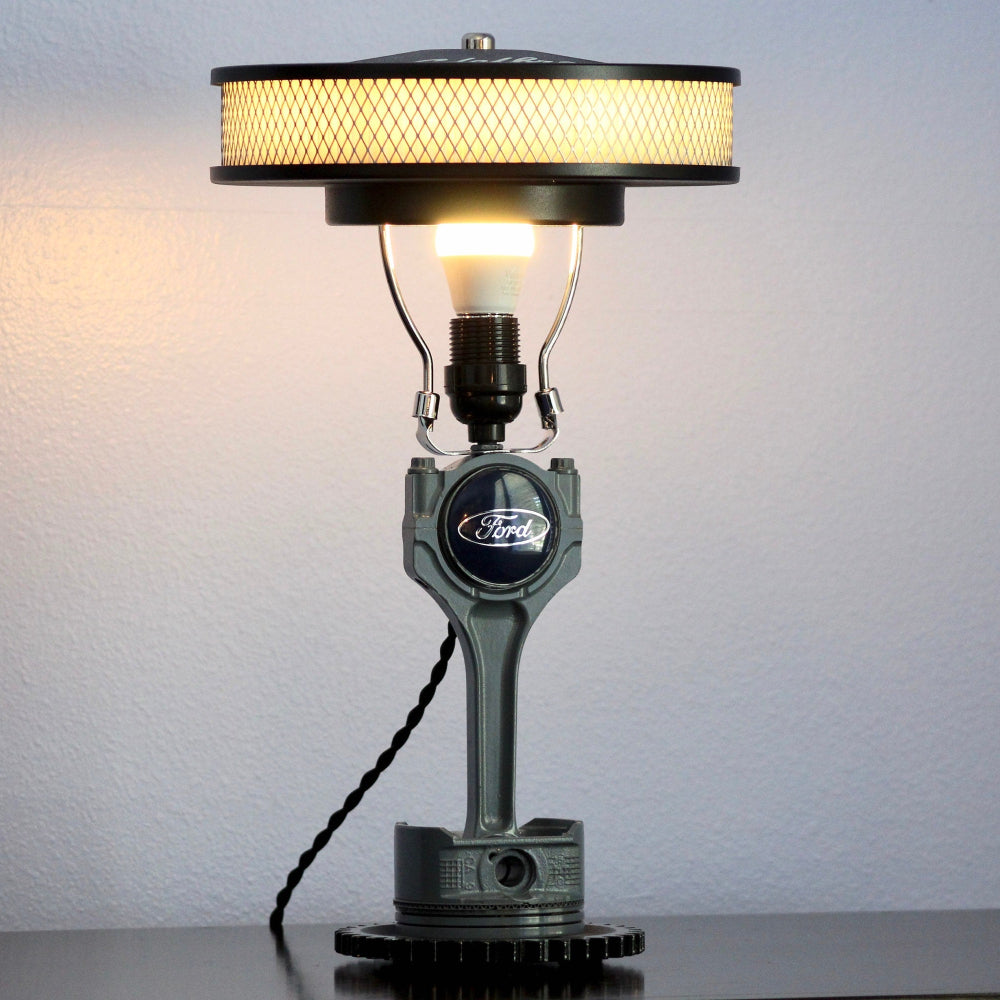 Chevy piston lamp designed for garage decor, handcrafted from real automotive components with bold mechanical appeal.