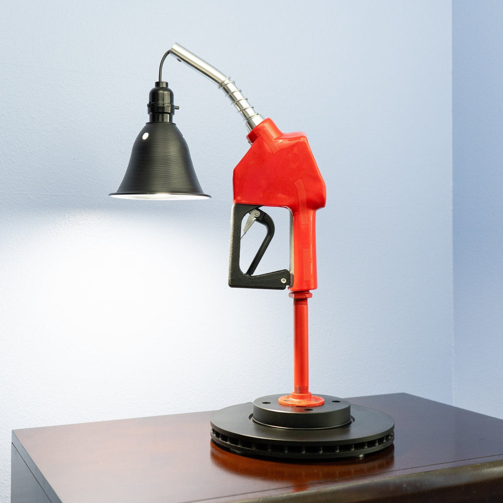 Gas pump nozzle lamp made from real automotive parts, combining vintage fuel station style with functional lighting.