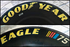 Tire table with custom glass and plexiglass tabletop for strength and clarity.