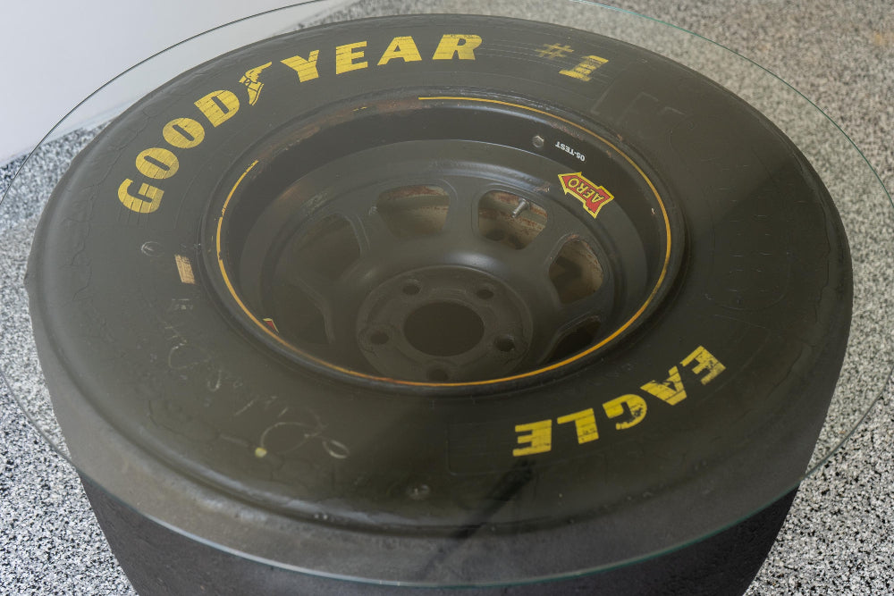 Handcrafted NASCAR tire table made from real racing parts, built one at a time for unique automotive home decor.