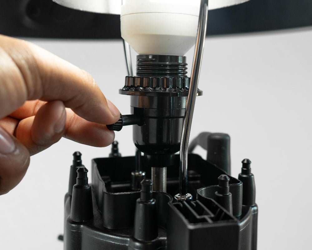 Industrial style black car parts lamp crafted from genuine automotive components for rugged decor.