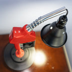 Industrial gas pump lamp built from real car parts, blending rugged mechanics with practical interior lighting.