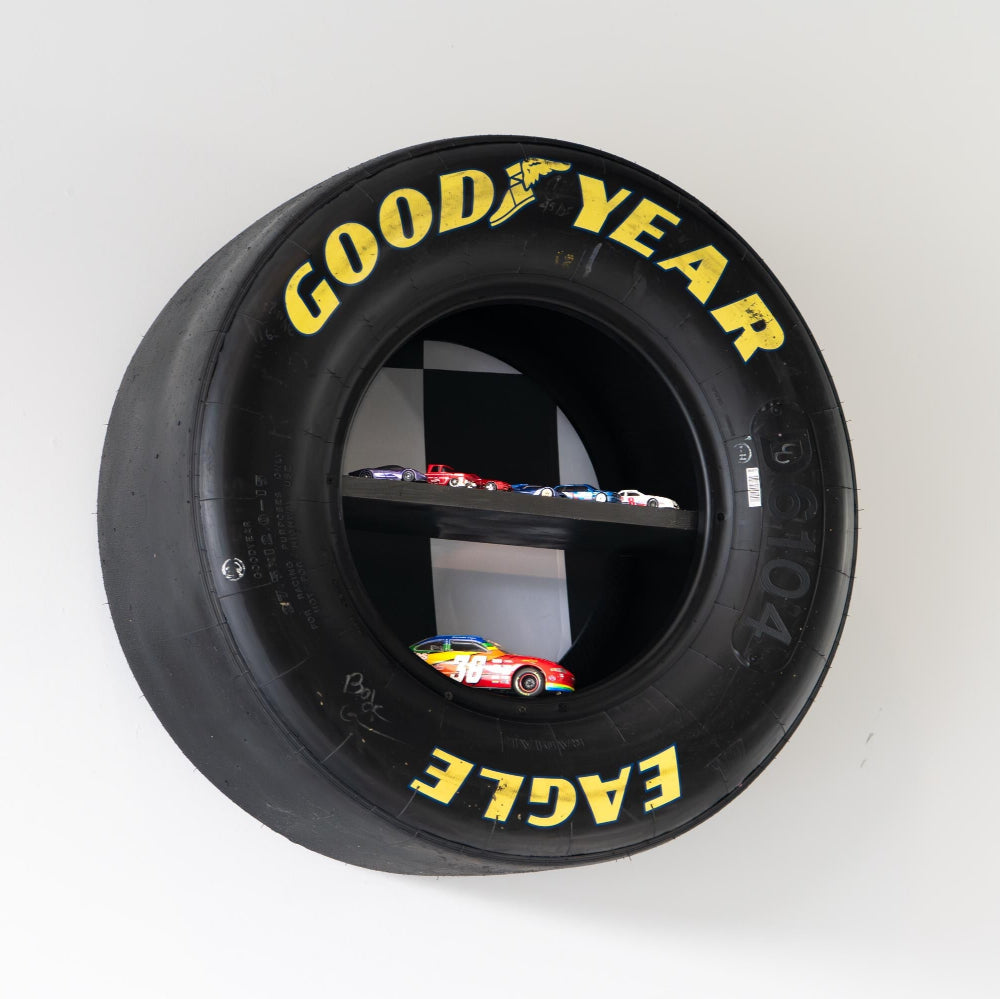 NASCAR collectible display shelf built from authentic race tire with internal shelving.