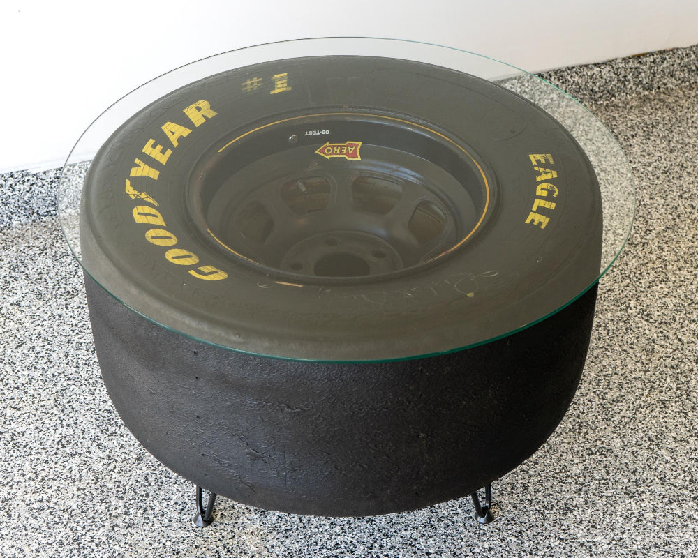 NASCAR tire table featuring a flush plexiglass top, providing a smooth surface while preserving the bold racing tire look.