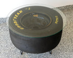 NASCAR tire table featuring a flush plexiglass top, providing a smooth surface while preserving the bold racing tire look.