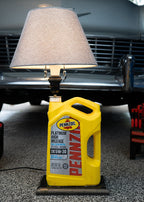 Close up detail of Pennzoil lamp showing epoxy finish and wood base texture.