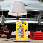 Pennzoil lamp made from real oil jug mounted on oak base with glossy epoxy drip design.