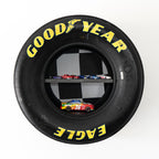 Wall shelf built from race used tire designed to display collectibles trophies and racing memorabilia.