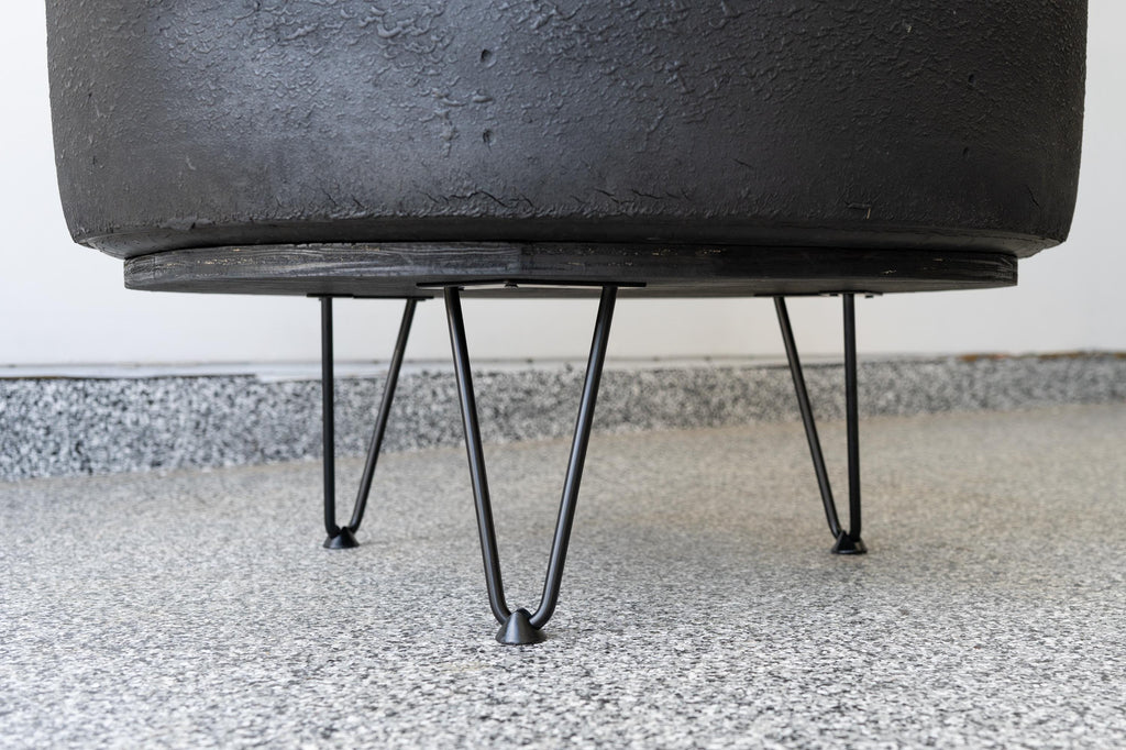 Racing tire coffee table built from a retired NASCAR tire, designed for automotive-themed spaces and racing enthusiasts.