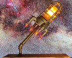 Rocket lamp featuring LED flame effect lighting that creates a realistic glowing launch style display.