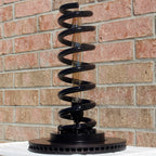 Spring lamp anchored to a refinished brake rotor base for stability and bold automotive character.