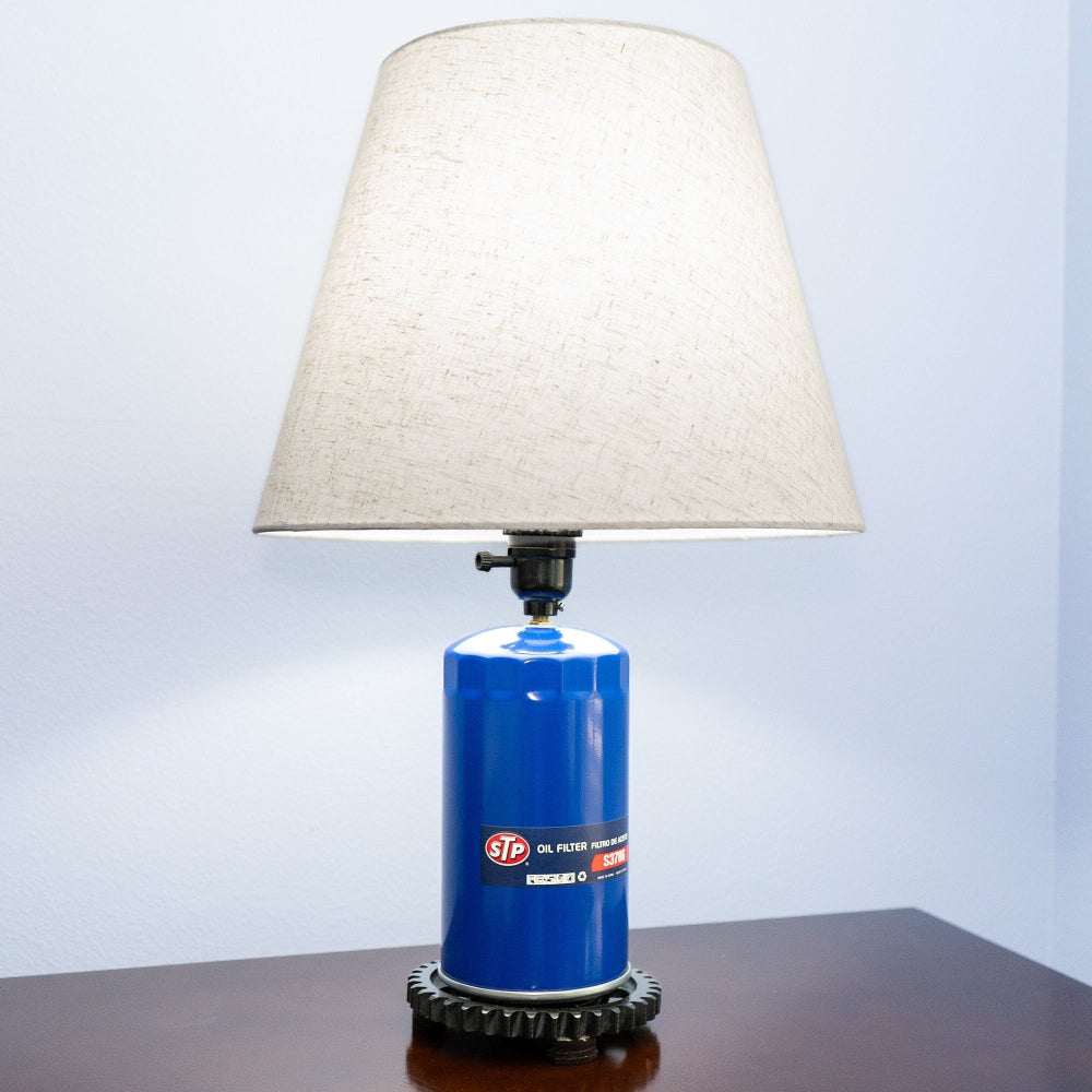 STP oil filter lamp built from real automotive parts, blending classic branding with industrial style lighting.