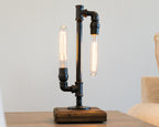 Symmetrical pipe lamp with balanced structure designed as functional lighting and statement decor.