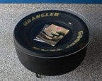 Two tier racing tire coffee table with upper and lower display surfaces.