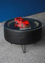 Automotive shop tire coffee table crafted from a real NASCAR racing tire with industrial strength legs and wood base.