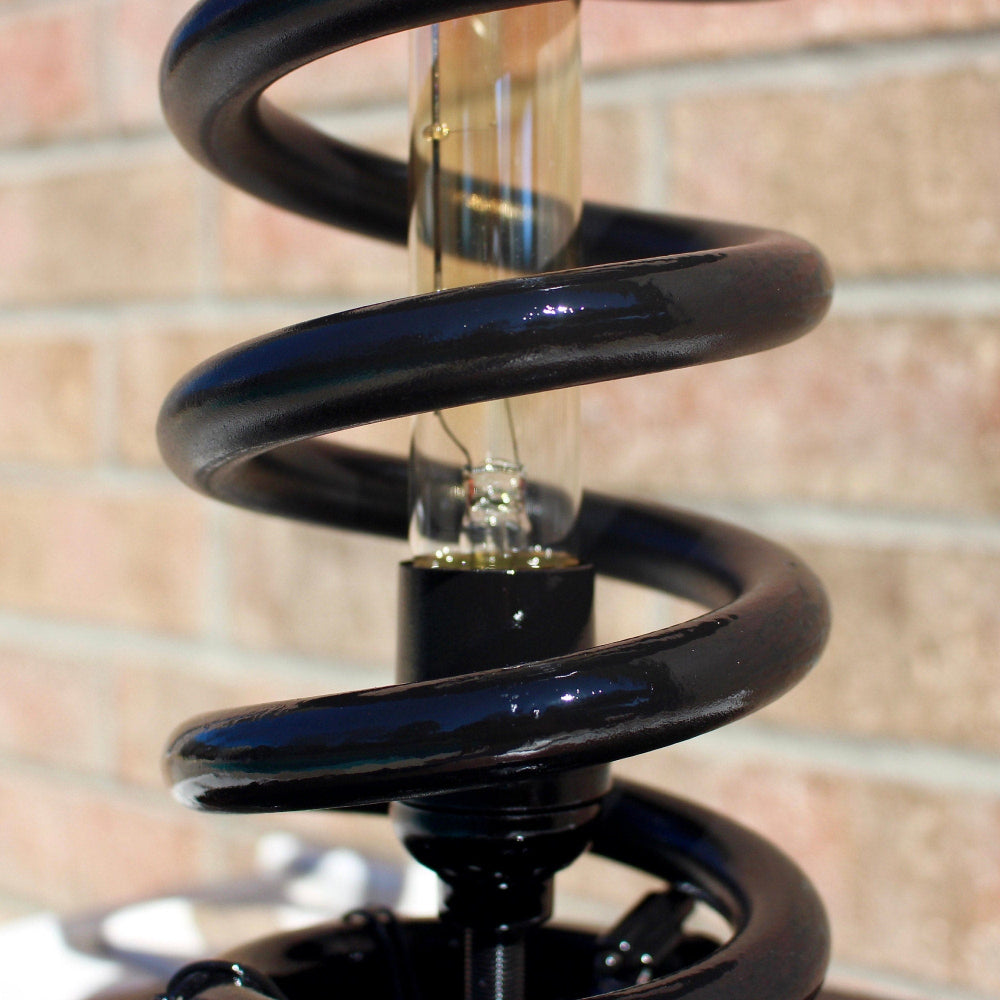 Upcycled car spring light repurposed from real automotive parts to create a unique home decor piece.