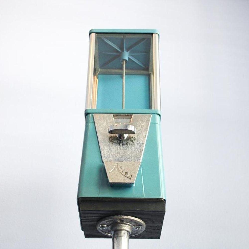 Vintage candy dispenser gumball machine restored for use, combining functional coin operation with nostalgic decor style.