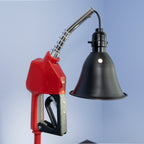 Vintage inspired gas nozzle lamp crafted from an authentic fuel handle and mounted on a matte black brake rotor base.