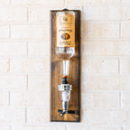 Wall mounted liquor dispenser with shot pour system designed for clean home bar organization.