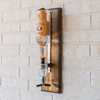 Wall mounted shot pour dispenser designed to deliver consistent pours with minimal mess.